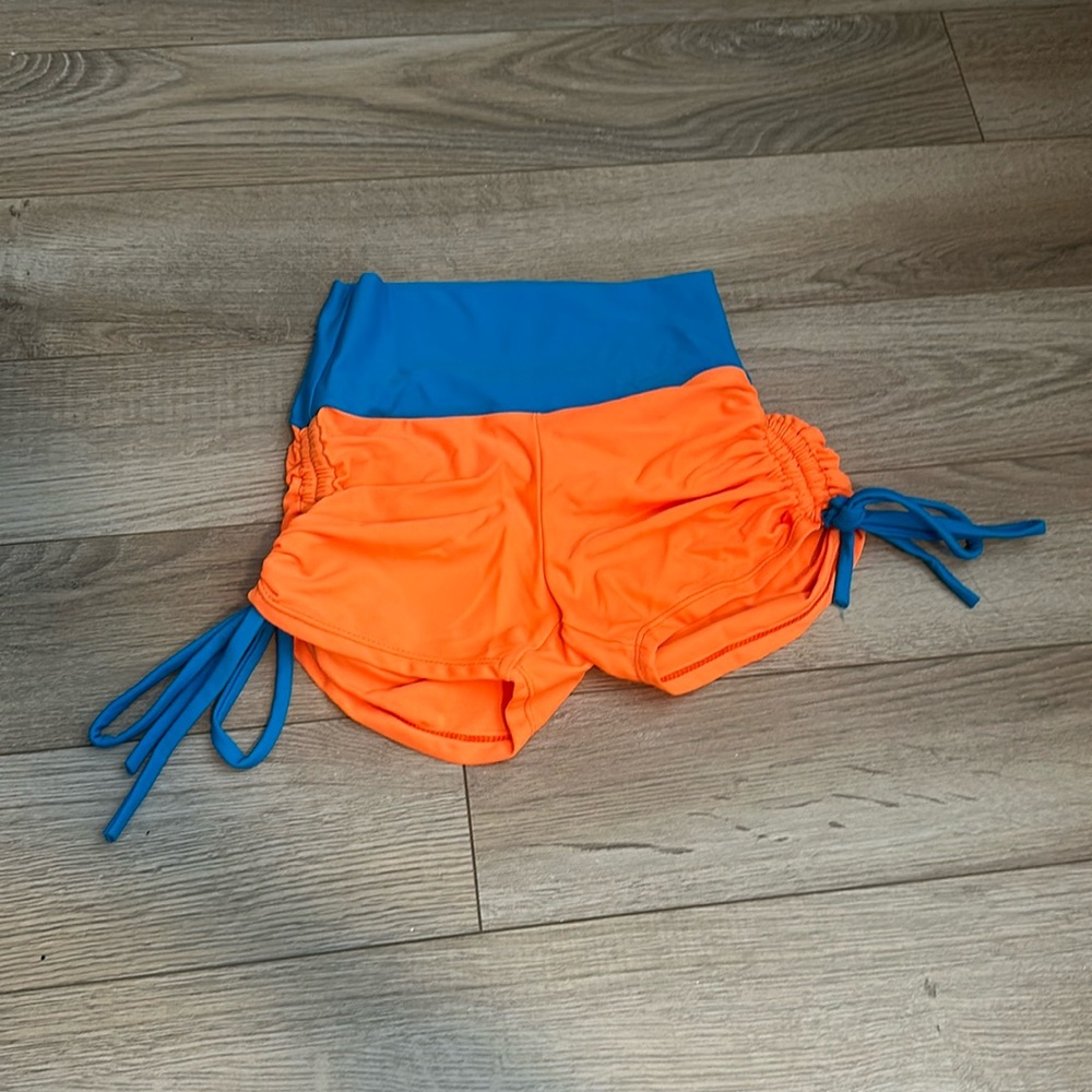 Orange and Pink Ilogear shorts. Very cute! In perfect condition only worn once.
